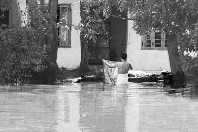 Living Below the Sea Level - Bathing on the banks of a Pamba river channel in Alappuzha district, Kerala